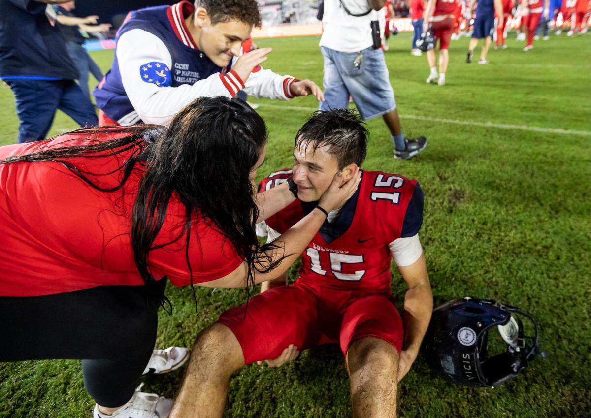 Columbus Explorers quarterback Alberto Mendoza (15) is congratulated after his team defeated the Apopka Blue Darters during their 2022 FHSAA State Championships-Class 4M football game on Saturday, Dec. 17, 2022, in Fort Lauderdale, Fla.