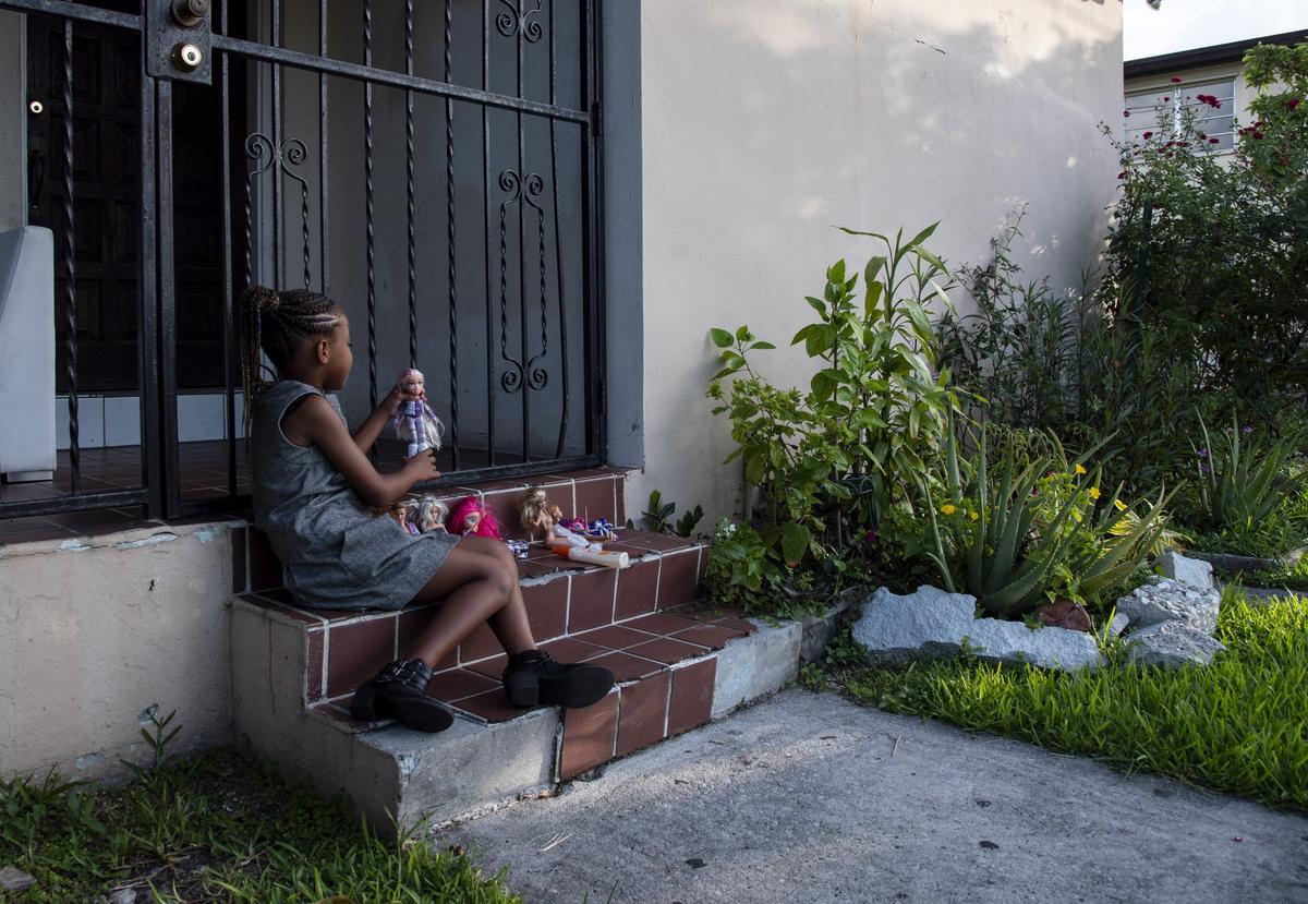 Zeevah Venord, 8, plays outside of her Miami home. Zeevah’s mother, Sherry Hunt, has advocated for a new Florida law, which went into effect July 1, that allows women in abusive situations to receive unemployment benefits. Hunt left an abusive situation with Zeevah’s father in 2014.