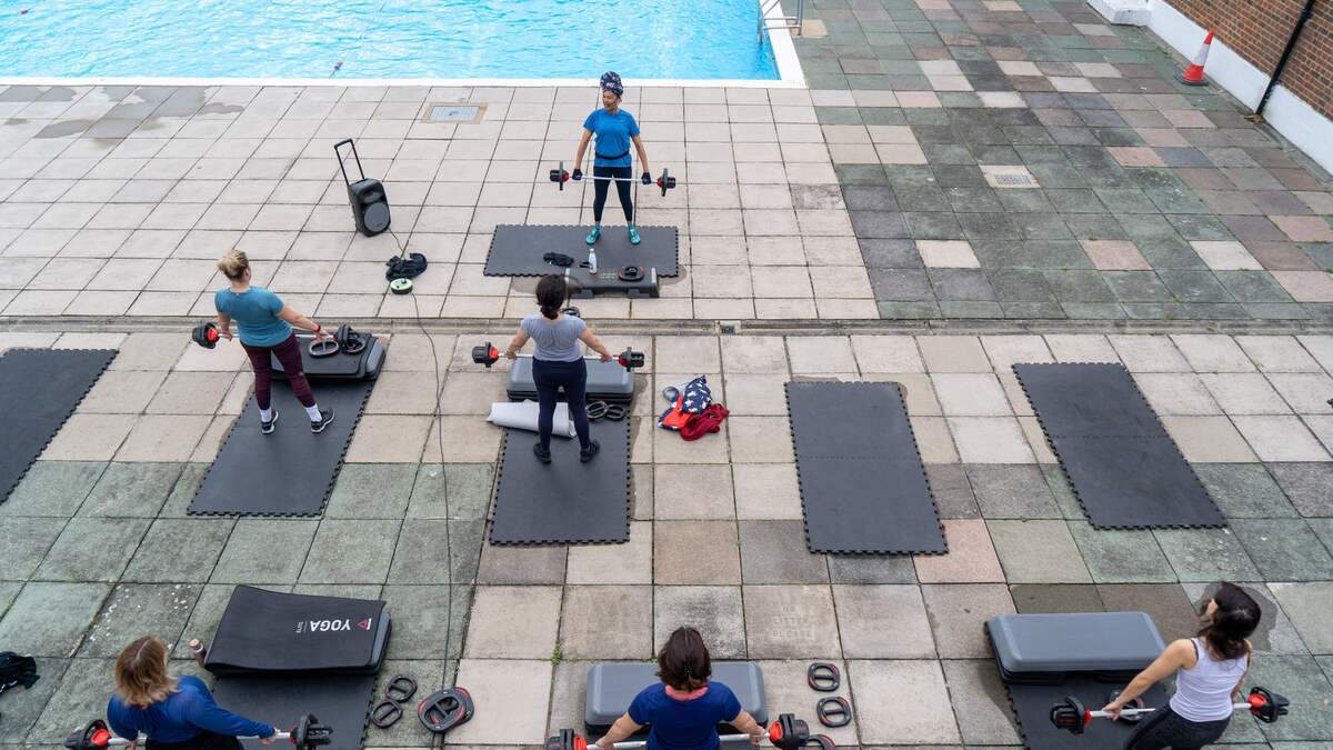 Members of Brockwell Lido, Gym and Health Spa takes part in a Body Pump exercise class in Brockwell Park in south London on May 17, 2021 as Covid-19 lockdown restrictions ease.