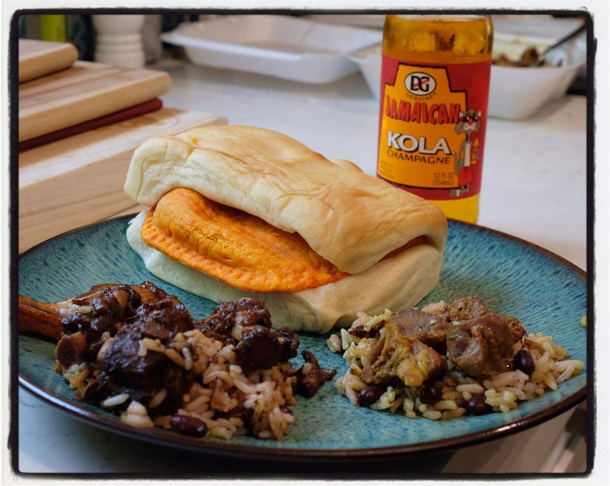 Oxtail stew (left) or curried goat over rice and peas are go-to dishes at Clive’s Café in Little Haiti. A Jamaican patty stuffed inside a hunk of coco bread, washed down with a Jamaican Kola, is the only meal you need in a day.