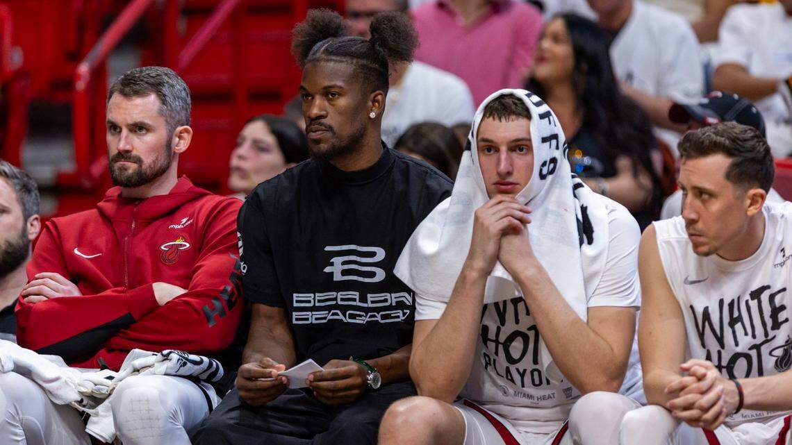 Miami Heat forward Jimmy Butler looks on from the bench between Miami Heat forward Kevin Love (42) and forward Nikola Jovic (5) during the second half of Game 3 of their first-round playoff series at Kaseya Center in Miami on Saturday, April 27, 2024.