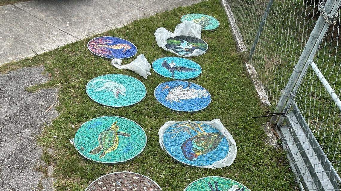 Two Miami-Dade County employees are accused of stealing artwork worth over $50,000 from PortMiami and were charged with grand theft.