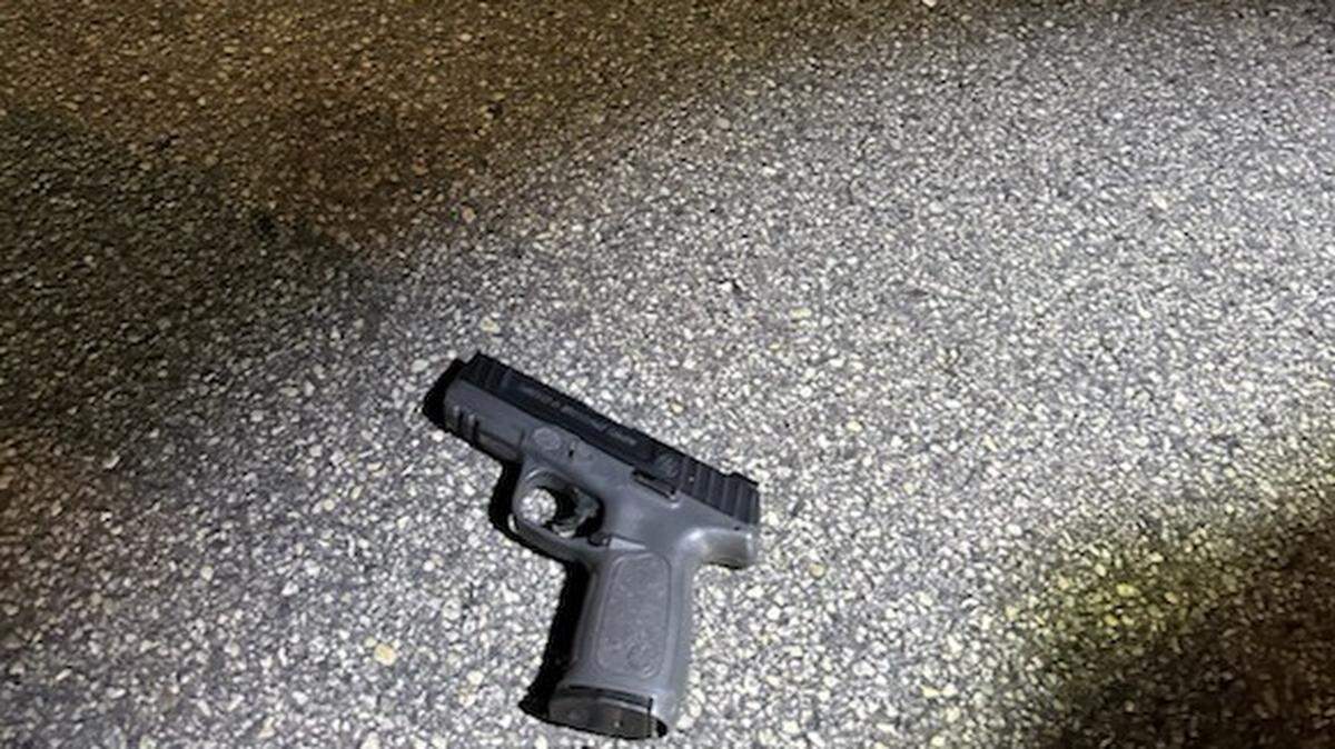 A handgun is on the concrete of the street near Northwest 17th Avenue and 87th Street Monday night, Feb. 24, 2026. The Miami-Dade Sheriff’s Office said the weapon was recovered after a deputy shot an armed man during a traffic stop.