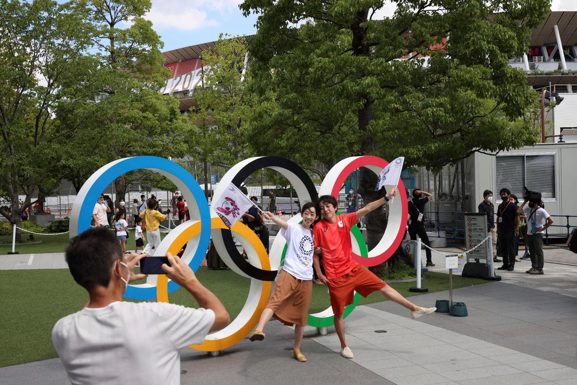 Athletes in the scaled-back Tokyo Olympics compete in the two-person flag-wave event.