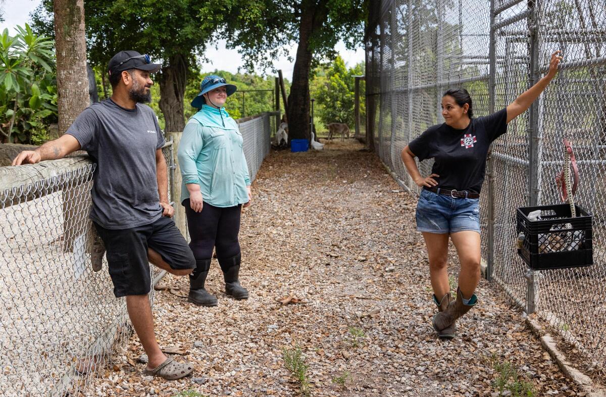 Jeff Rivera and Martha talk while waiting for Dr. Douglas Mader to finish vaccinating an animal on Aug. 13, 2023. Jeff lives in Naples during the week for his construction job that supports their family, as neither of them take a salary for their work at the outpost. On the weekends, he balances family time with odd jobs that Martha and Amanda cannot do around the outpost.