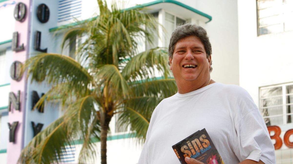 Alex Daoud, former mayor of Miami Beach, stands on Ocean Drive holding his new book “Sins of South Beach” on Nov. 4, 2007. Daoud, who was indicted for misusing his public office in the 1990s, has written a tell-all book in which he details the bribes he took, the women he slept with and the vigilante rides he took with Miami Beach police during the Miami Vice days.