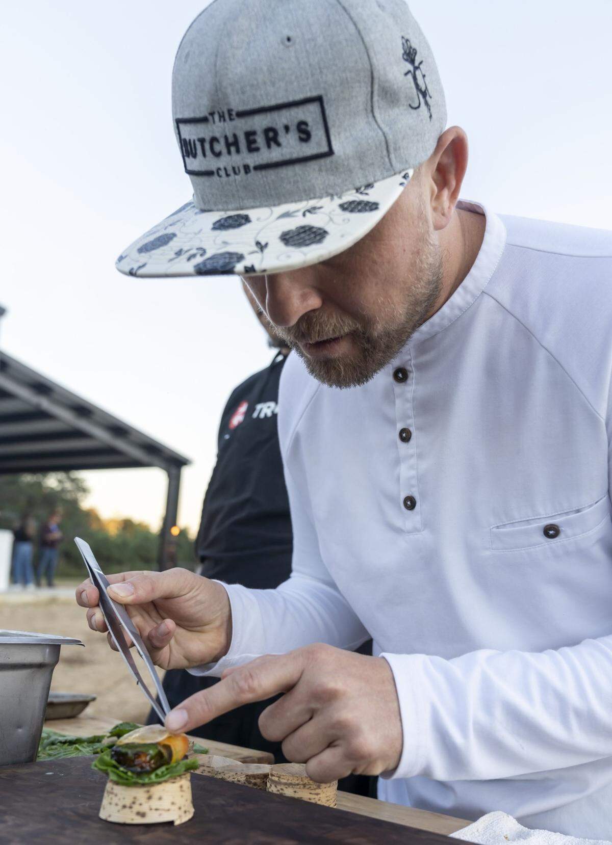 Chef Jeremy Ford plates an appetizer at the first Ford’s Farm dinner at his farm in Redland.