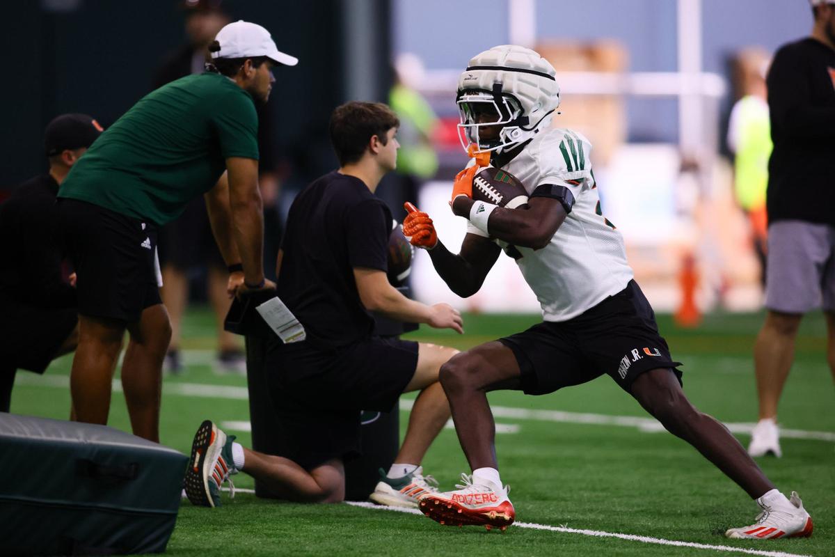 Miami Hurricanes running back Chris Johnson Jr. (24) runs with the football during training camp at the Carol Soffer Indoor Practice Facility at the University of Miami in Coral Gables, Florida, Saturday, August 3, 2024.