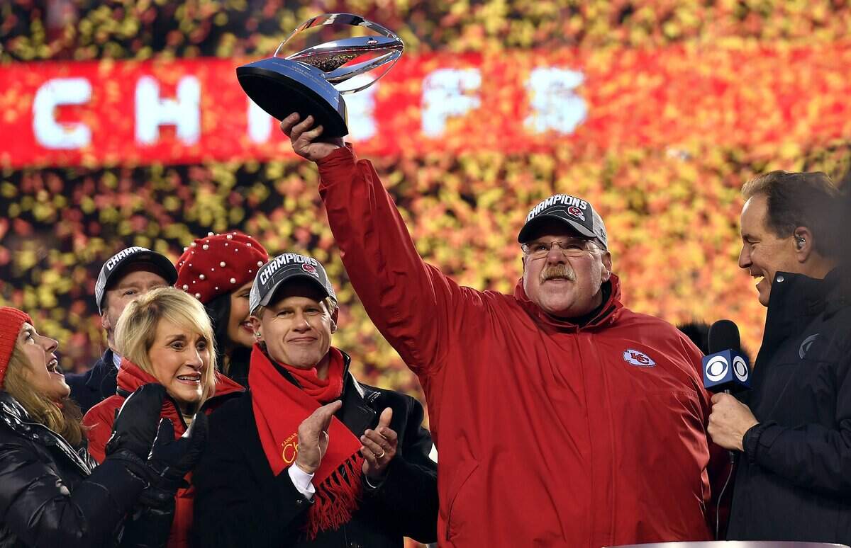Chiefs coach Andy Reid hoists the AFC championship trophy after Kansas City beat the Tennessee Titan 35-24 Sunday at Arrowhead Stadium and advance to the Super Bowl in Miami.
