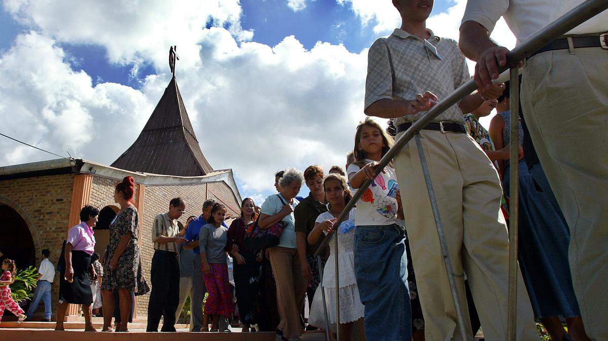 Cuban faithful leave the Evangelical Church of Canaan in Miller near Santa Clara central Cuba in 2003. The small church that American pastor Paul Northrup planted in central Cuba more than 50 years ago has grown and thrived since he left in 1959, becoming a small part of a broad movement that Cuban evangelicals have built across their socialist nation.
