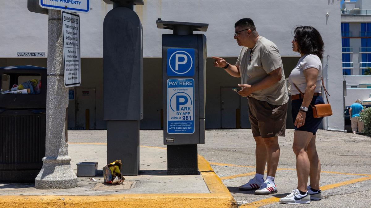 Visitors pay for parking inside a private parking lot owned by Asta Parking Inc. at 365 Taylor St. on Thursday, July 18, 2024, in Hollywood, Florida.
