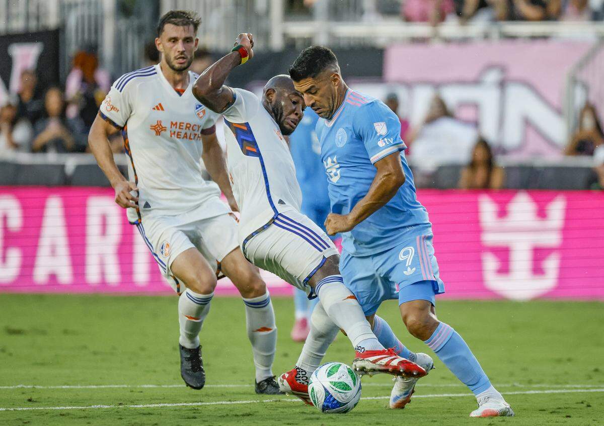 Inter Miami forward Luis Suárez (9) is kicked in the thigh by FC Cincinnati midfielder Brian Anunga (27) in the first half at Chase Stadium in Fort Lauderdale, Florida on Saturday, July 26, 2025.