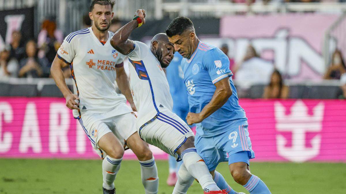 Inter Miami forward Luis Suárez (9) is kicked in the thigh by FC Cincinnati midfielder Brian Anunga (27) in the first half at Chase Stadium in Fort Lauderdale, Florida on Saturday, July 26, 2025.