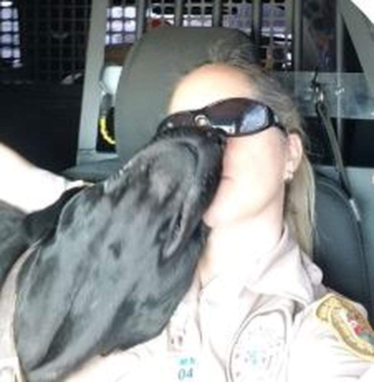 A TikTok profile picture shows Deputy Carle Miranda Blum wearing a Miami-Dade Police Department uniform while sitting with a dog.