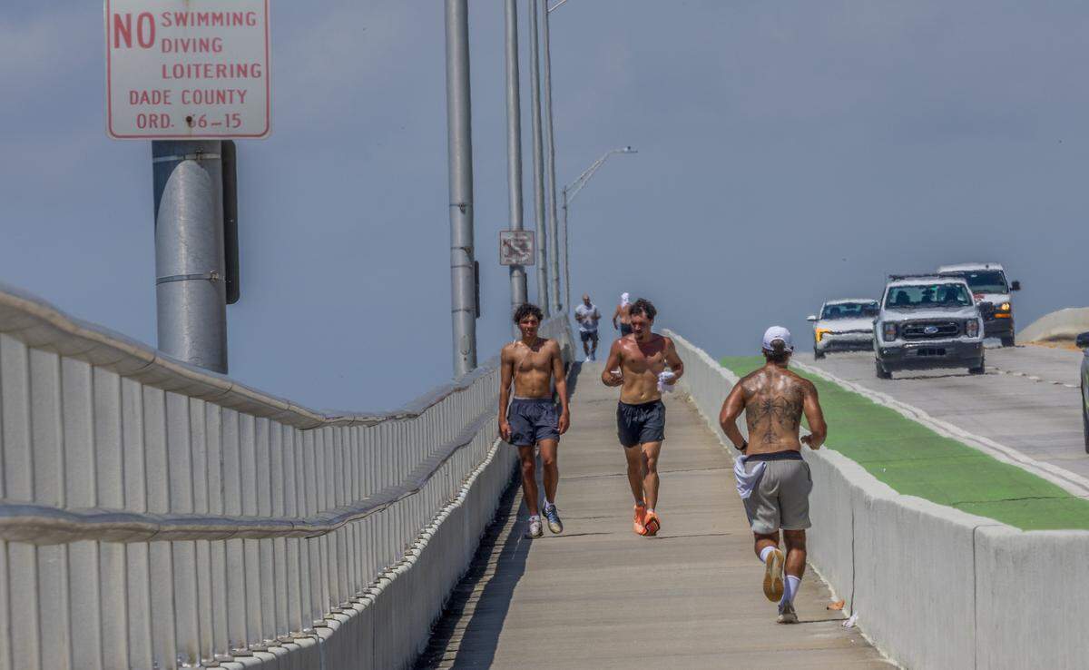 Joggers runs along the Rickenbacker Causeway bridge enjoying the nice weather as South Florida swelters under a heat advisory that warns of feels-like temperatures of 108, thoughts turn to the coming long Labor Day weekend in Miami , on Wednesday, August 27, 2025.