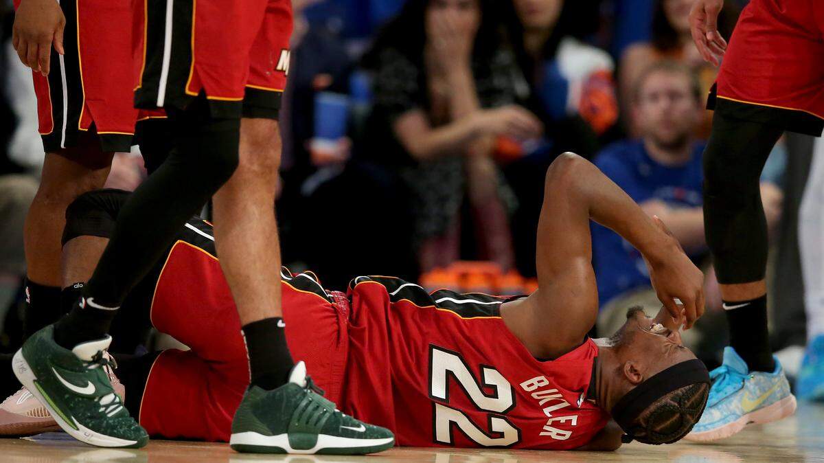 Miami Heat forward Jimmy Butler (22) reacts after landing awkwardly on his left foot after a collision with New York Knicks guard Josh Hart (not pictured) during the fourth quarter of game one of the 2023 NBA Eastern Conference semifinal playoffs at Madison Square Garden.