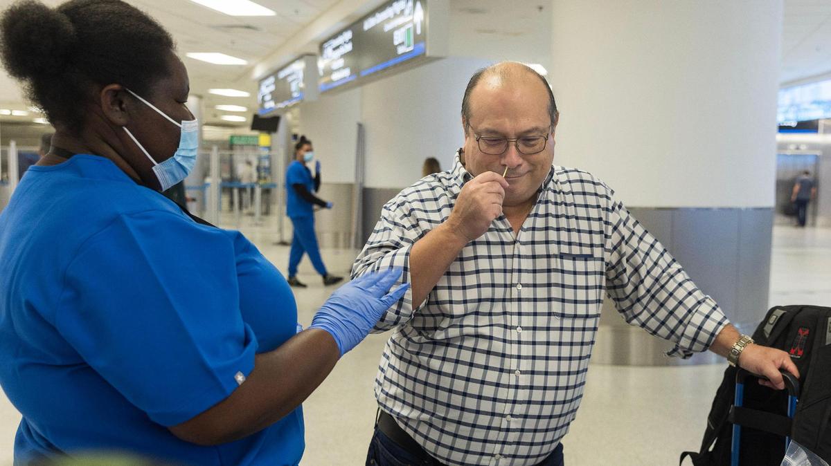 Traveler Carlos Avila, arriving from Barbados, swabs his nose to test for COVID variants and other contagious viruses as part of a nationwide effort to track new and emerging infectious diseases, on Thursday, March 14, 2024.