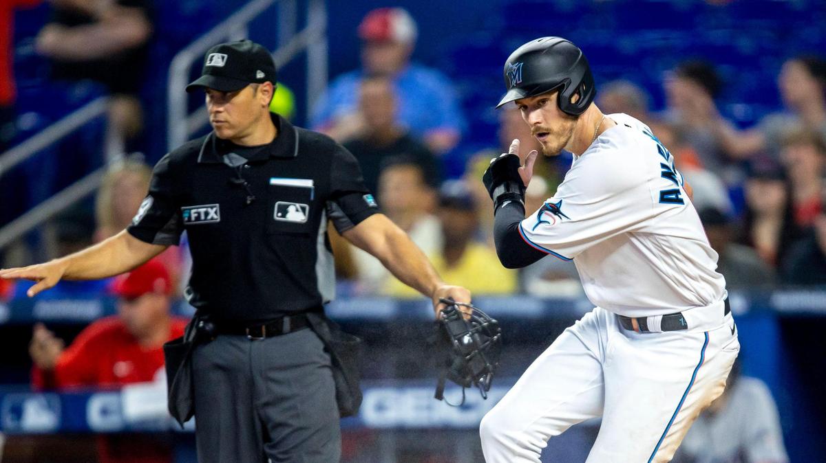 Miami Marlins base runner Brian Anderson (15) reacts to scoring after crossing home plate during the third inning of a baseball game against the Philadelphia Phillies at LoanDepot Park on Sunday, April 17, 2022 in Miami, Florida.