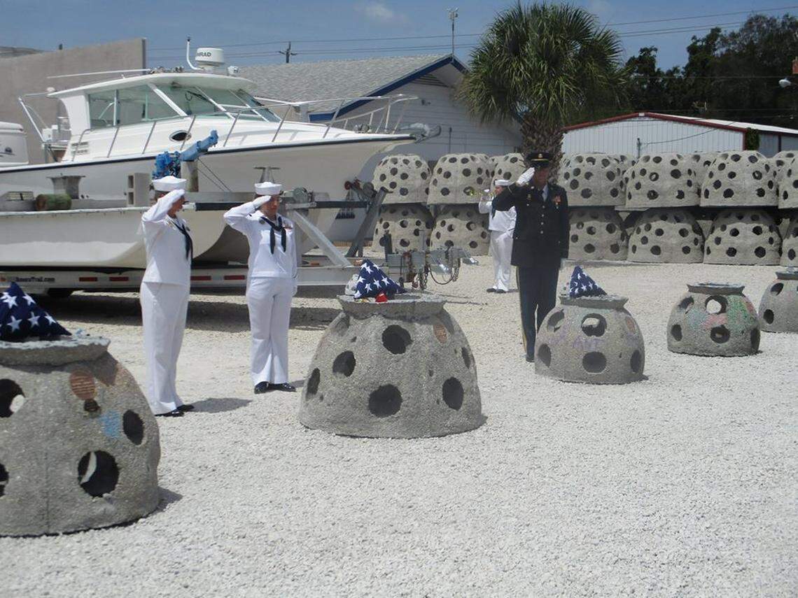 Members of the U.S. Navy give military honors to reef balls containing the remains of sailors in Sarasota, Florida.