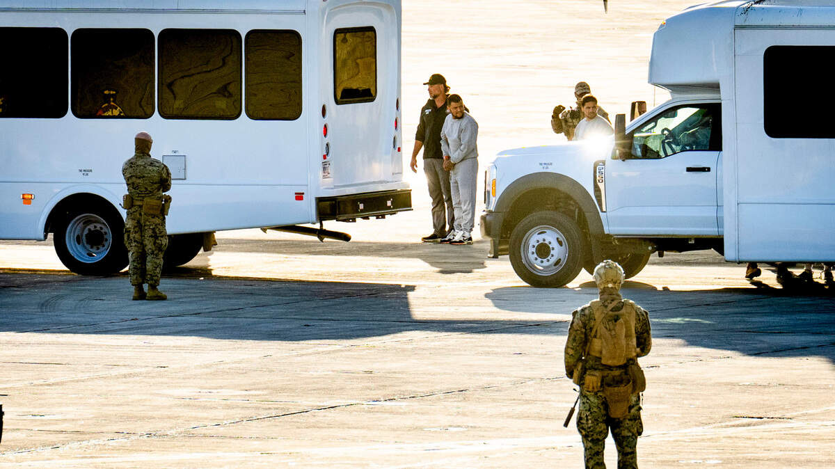 ***EDS.: PHOTO HAS BEEN REVIEWED BY U.S. MILITARY CENSORS *** FILE — Security forces escort men brought from a Department of Homeland Security facility in El Paso off a C-130 military plane at the U.S. naval base at Guantánamo Bay, Cuba, Feb. 7, 2025. The Trump administration has said little about the Venezuelan men who were transferred from Texas to the U.S. military base in Cuba. (Doug Mills/The New York Times)