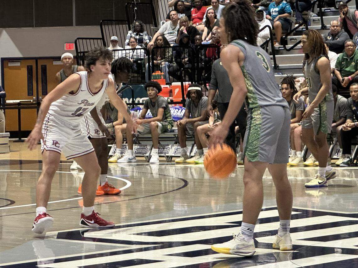 Pembroke Pines Charter guard Alex Vardakis (left) guards Fleming Island’s Bryce Robinson (3) during Friday’s Class 5A state championship game at UNF Arena in Jacksonville, Fla.