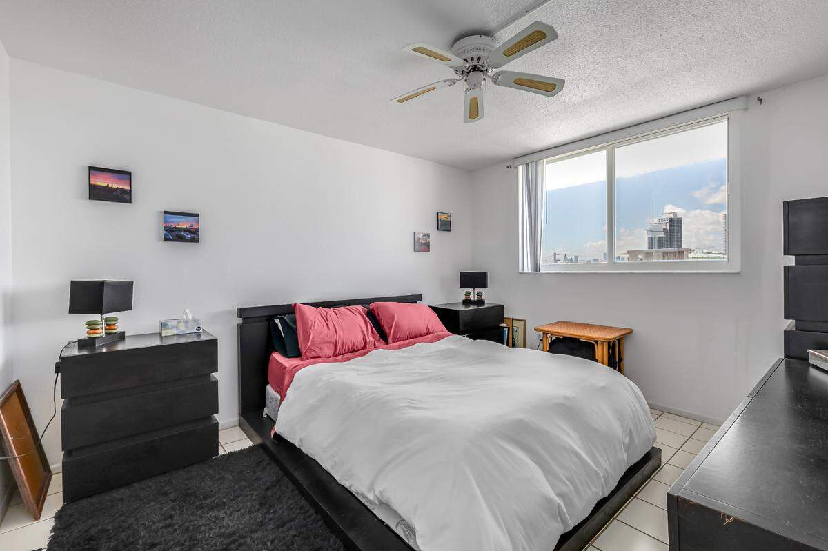 The South Beach apartment has one bedroom, pictured above, with a slider window overlooking the street.