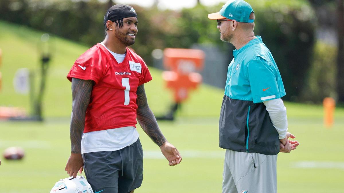 Miami Dolphins quarterback Tua Tagovailoa (1) speaks with quarterback and pass game coordinator Darrell Bevell during mandatory minicamp at the Baptist Health Training Complex in Miami Miami Gardens, Florida on Tuesday, June 10, 2025