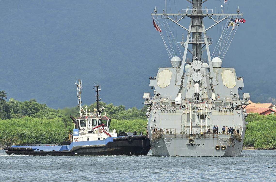 A tug boat assist the USS Gravely warship to dock at Port of Spain, the capital of Trinidad and Tobago, on Oct. 26, 2025.          