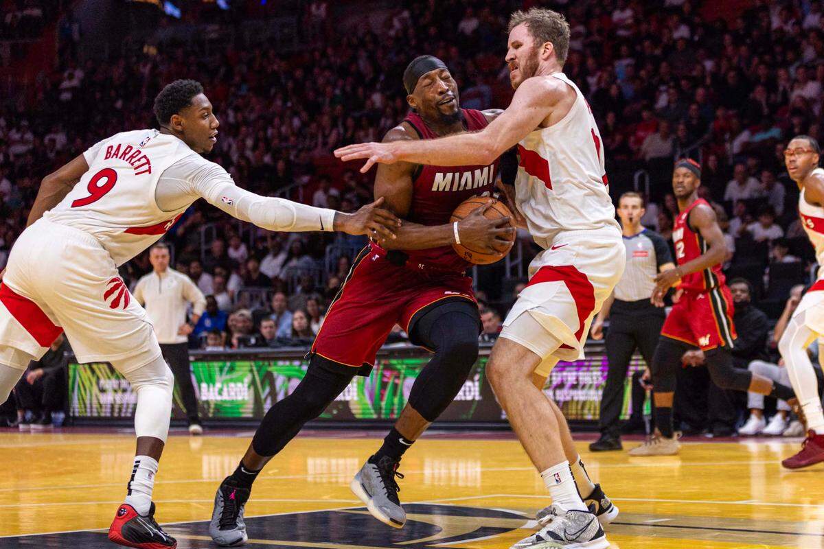 Miami Heat center Bam Adebayo (13) steps into the paint while defended by Toronto Raptors center Jakob Poeltl (19) during the second half of an NBA game at Kaseya Center on Friday, Nov. 29, 2024, in Miami, Fla