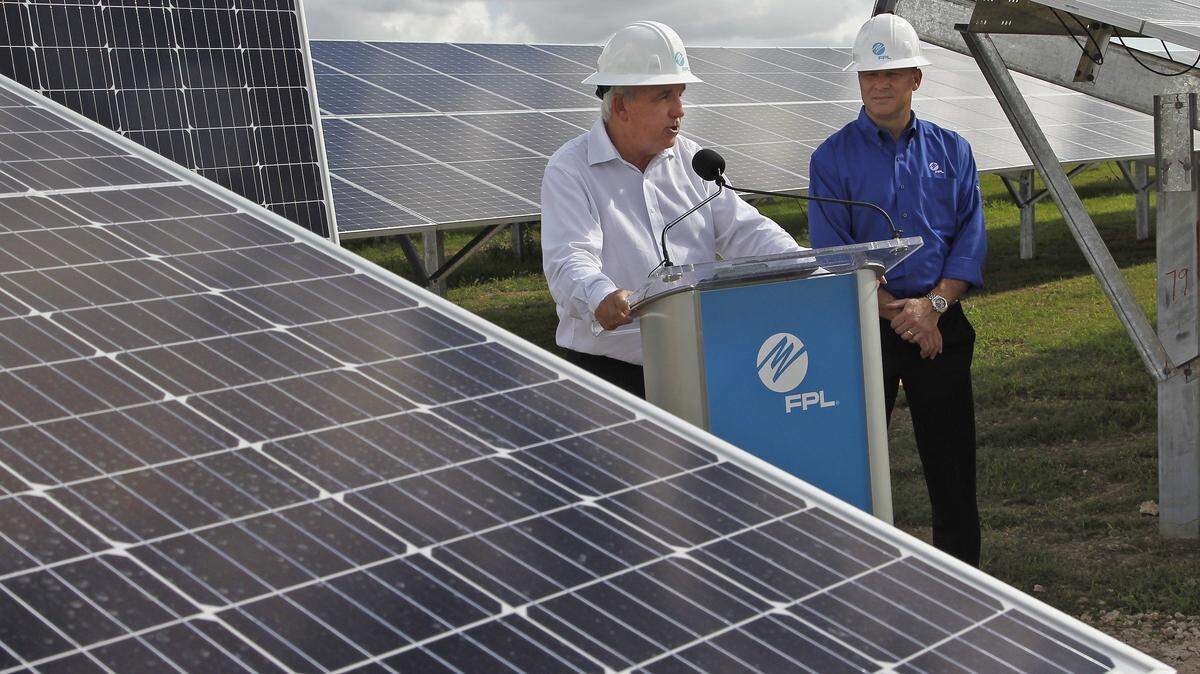 Florida Power & Light is asking for a $2 billion rate hike to fund infrastructure upgrades. An October 2018 file photo shows former Miami-Dade Mayor Carlos Gimenez with FPL President Eric Silagy.