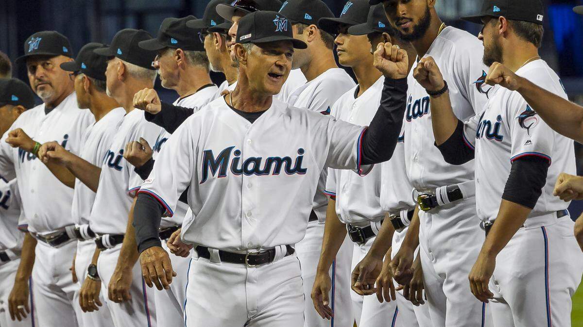 Miami Marlins manager Don Mattingly (8) greets players before the start of an Opening Day baseball game between the Miami Marlins and the Colorado Rockies at the Miami Marlins at Marlins Park on Thursday, March 28, 2019 in Miami, Florida.