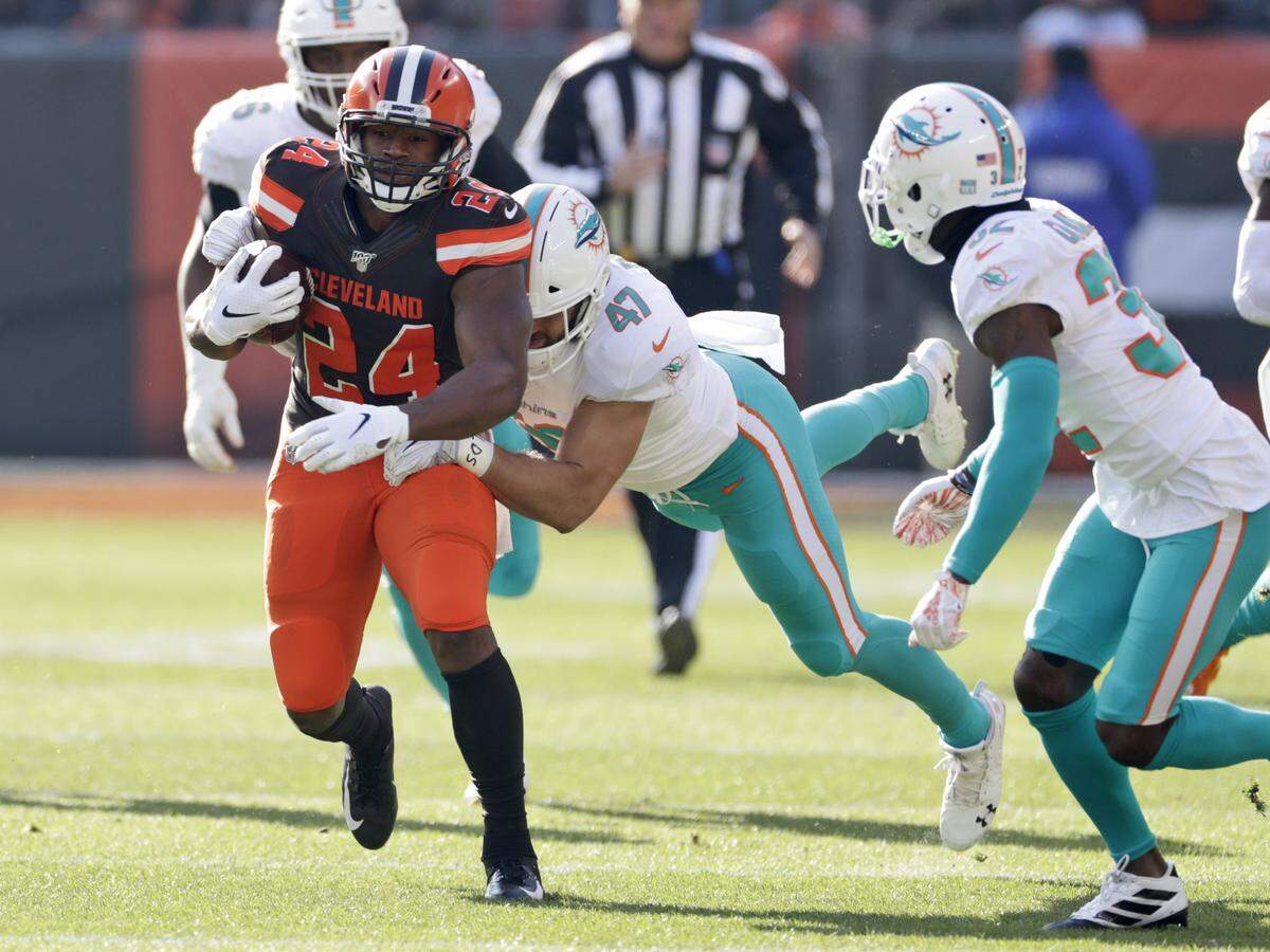 Cleveland Browns running back Nick Chubb (24) rushes against the Miami Dolphins during the first half of an NFL football game, Sunday, Nov. 24, 2019, in Cleveland.