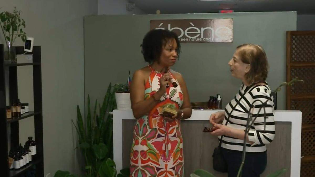 Ebene Naturals founder Fayola Nicaisse, left, talks to customer Vivian Haydar at the store in Miami.  