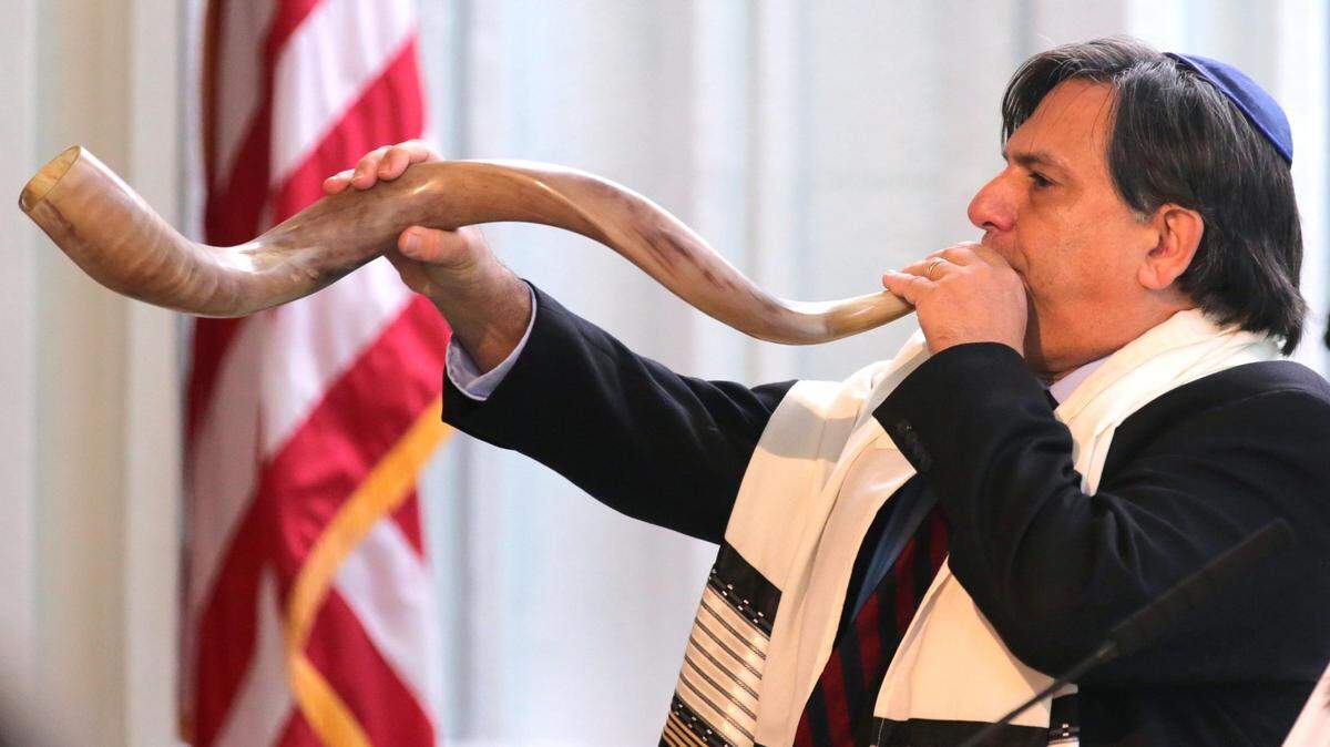 Dr. Edward Gross, a member a Temple Judea, blows a shofar during a ceremony to signal the start of Rosh Hashanah and the High Holy Days at Temple Judea in Coral Gables, Florida, on Monday, September 30, 2019.