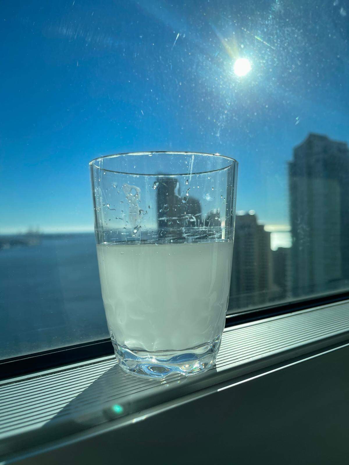 A glass of tap water poured by Met 1 resident Brian Andrews after a water-main pipe flooded nearby streets in downtown Miami.