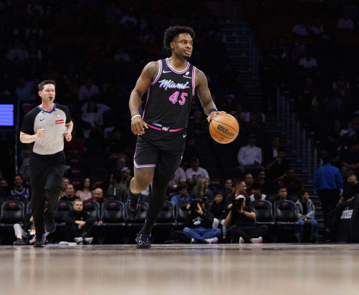 Miami Heat guard Davion Mitchell (45) dribbles the ball down the court during the first half of a game against the Philadelphia 76ers on March 30, 2026, at Kaseya Center in Miami.