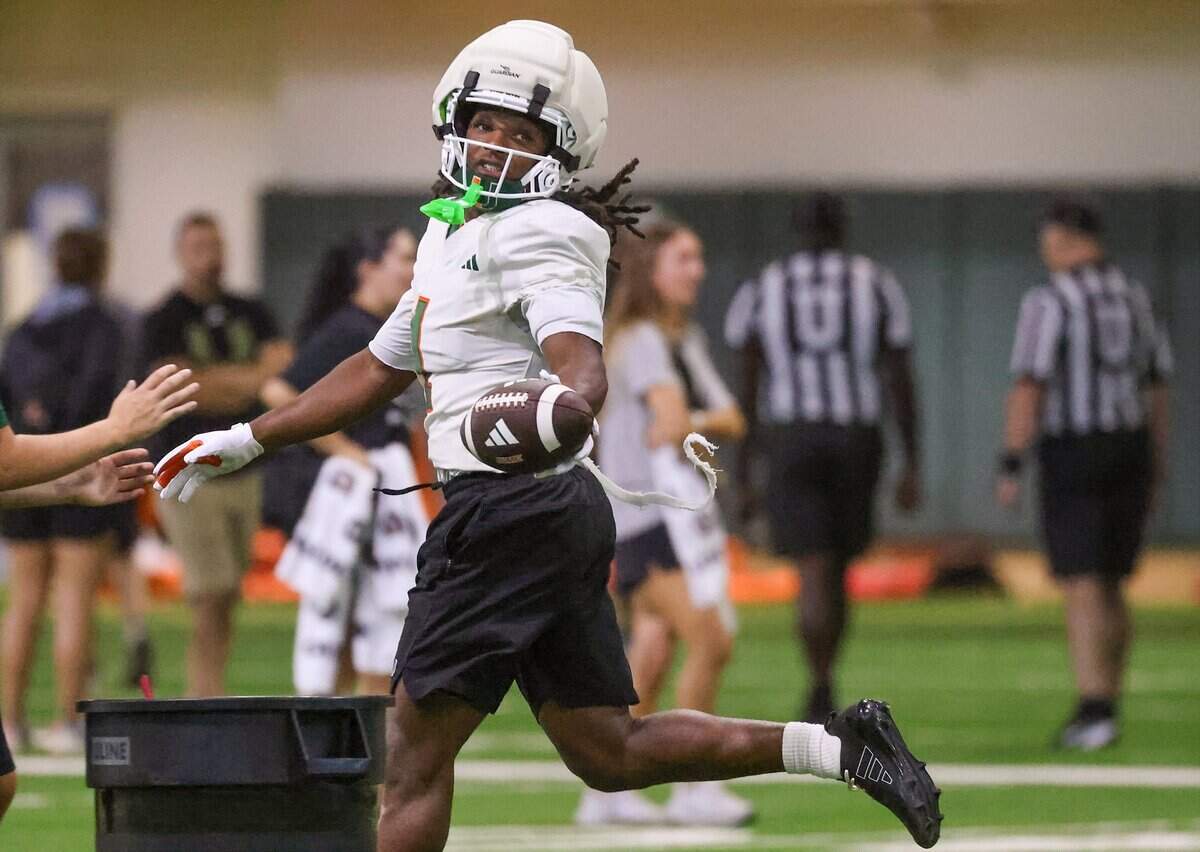 Wide receiver Malachi Toney (1) looks back after catching the ball as Miami Hurricanes football team practiced on Wednesday, Aug. 5, 2026, at the Carol Soffer Indoor Practice Facility in Coral Gables, Fla.