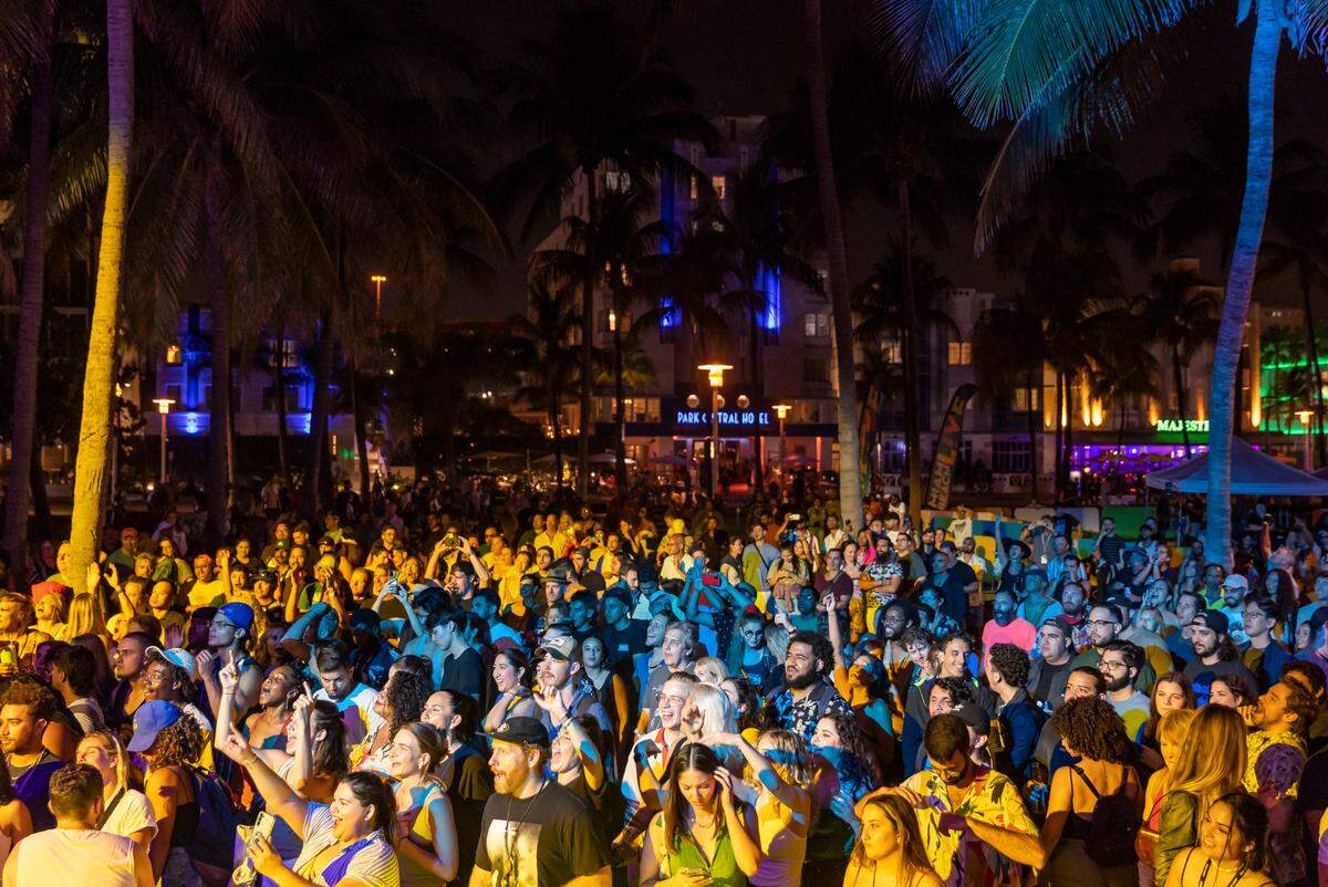 People watch a concert at Lummus Park during spring break on Saturday, March 11, 2023, in Miami Beach, Fla.