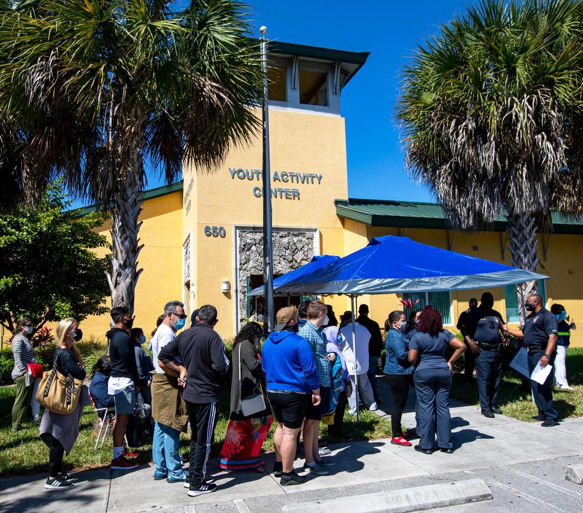 People wait in line to get vaccinated at the FEMA Florida City vaccination site located at the Florida City Youth Center on Sunday, March 7, 2021.