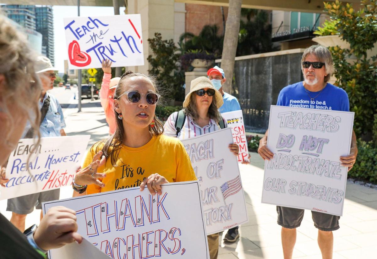 Alyssa Knight, left, 31, Dunedin Highland Middle School teacher, speaks with attendees about critical race theory and other topics outside the Moms for Liberty National Summit Friday, July 15, 2022, in Tampa.