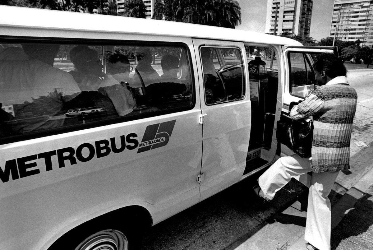 A passenger boards a county shuttle bus to cross the Venetian Causeway in 1985.