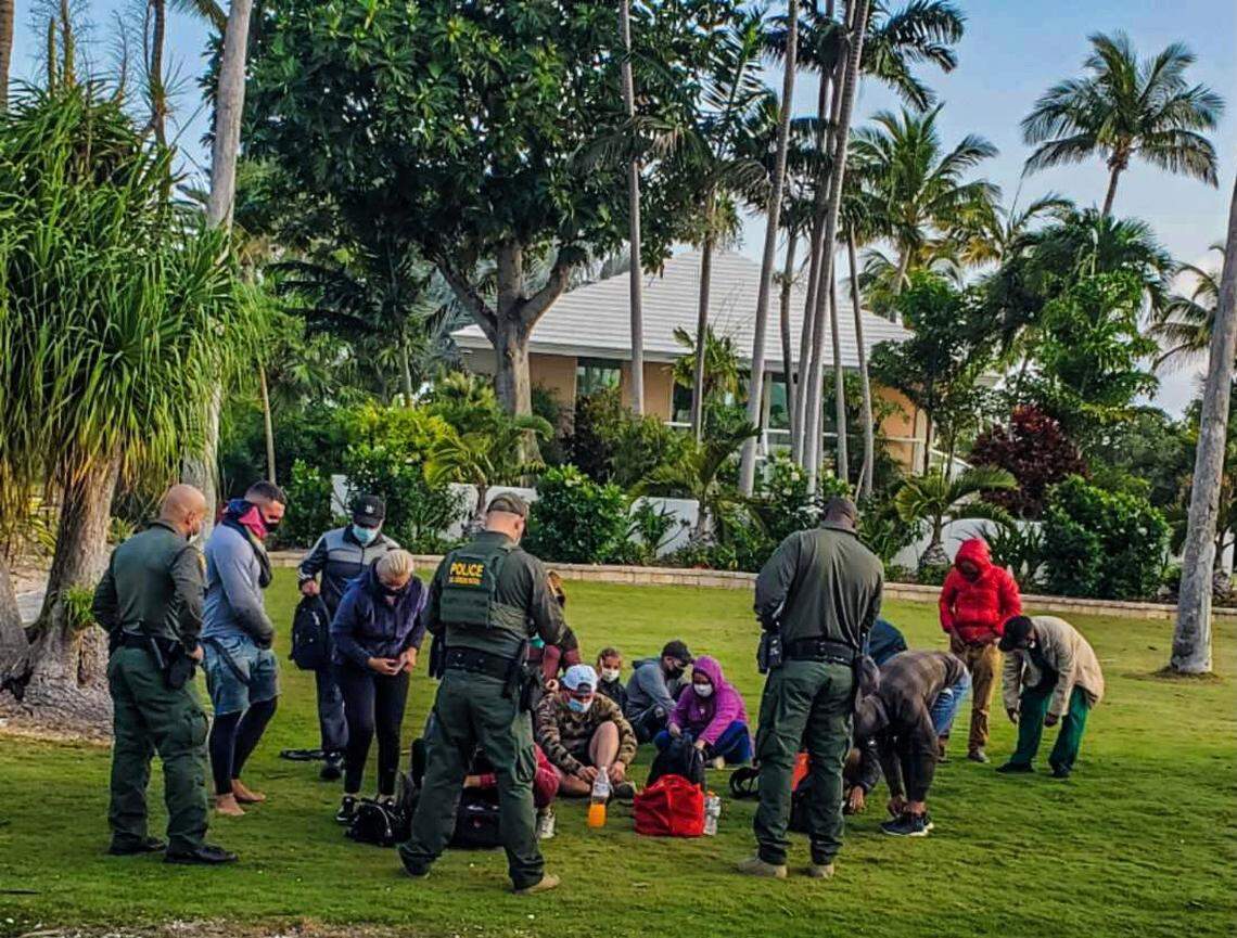 U.S. Border Patrol agents stand in front of Cuban migrants on Summerland Key in the Florida Keys Thursday, March 17, 2022.