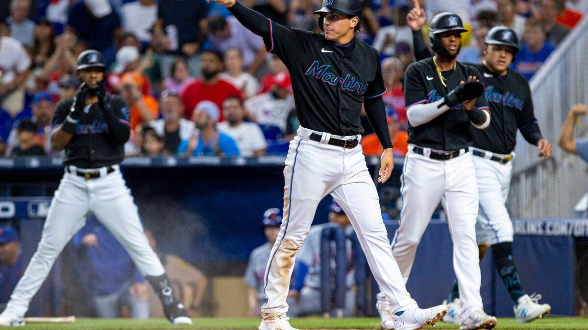 Miami Marlins base runner JJ Bleday (67) reacts after scoring a run with his teammates Avisaíl García (24) and Lewin Diaz (34) during the first inning of an MLB game against the New York Mets at loanDepot park in the Little Havana neighborhood of Miami, Florida, on Friday, July 29, 2022.