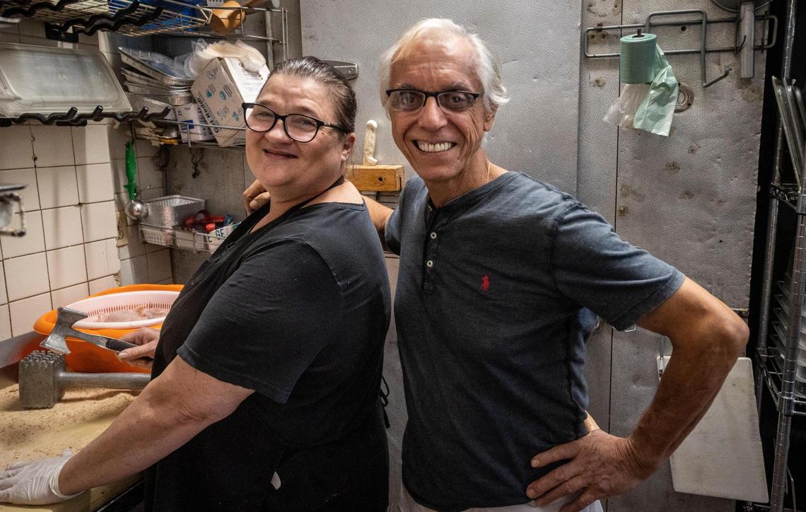 Roberto Auricchio, owner of Nunzio’s,right, poses for a photo with server Marcela Tondi in the restaurant’s kitchen.
