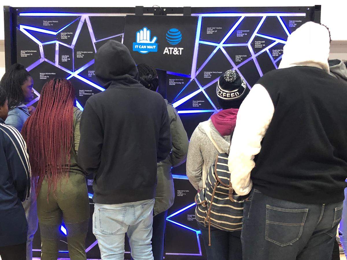Miami Norland High School students view a shattered glass wall that features the names of drivers that died while driving distracted during AT&T’s ‘It Can Wait’ Virtual Reality Tour. During the tour, the campaign made a stop in Miami to visit more than 200 students at Miami Norland High and Miami High schools to spread awareness about the dangers of distracted driving.