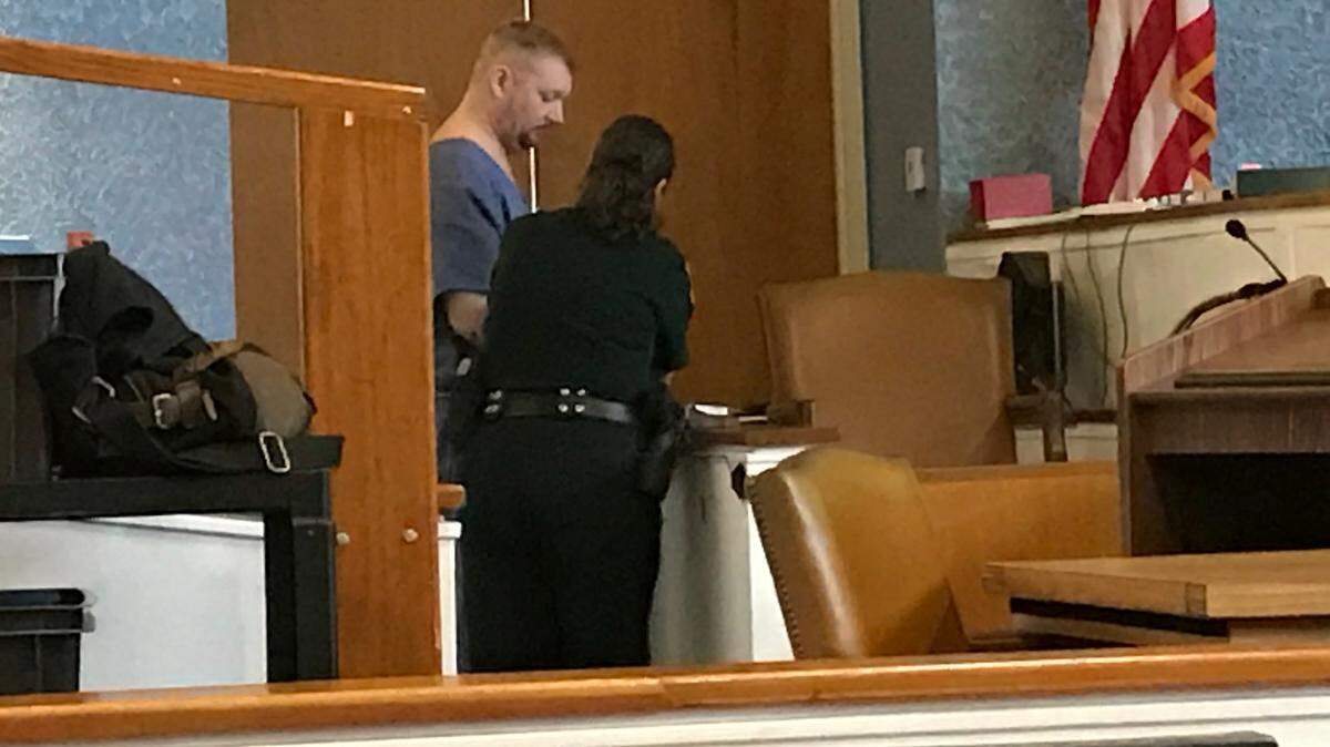 Monroe County Sheriff’s Office Deputy Dawn Augusto takes Jeremy Stigler’s fingerprints inside the Plantation Key courthouse Tuesday, Sept. 11, 2018. Augusto, now assigned to courtroom security, was the detective who arrested Stigler on a second-degree murder charge in November 2016.