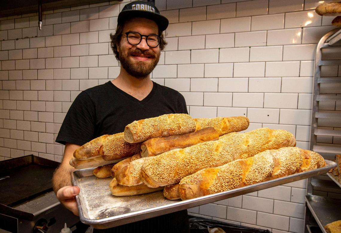 Pizzaiolo Doug Sorek shows off bread baked from scratch at Old Greg’s Pizza restaurant.