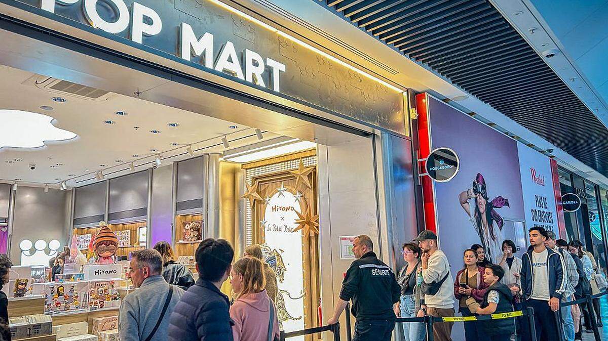 Storefront of the first POP MART shop in Lyon inaugurated at the Westfield La Part Dieu shopping center. In front of the entrance a crowd of curious visitors and collectors waits in line to discover the figurines and emblematic objects of the brand marking the public enthusiasm from the official opening of the store on October 1 2025 in Lyon France. (Photo by Albin Bonnard / Hans Lucas via AFP) (Photo by ALBIN BONNARD/Hans Lucas/AFP via Getty Images)          
