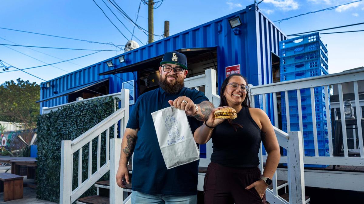 Jeff and Laura “Lala” Budnechky, owners of Apocalypse BBQ, show off a smashburger and a bag of fries at Lincoln’s Beard Brewing Co., where they have opened Lala’s Burgers and Fries. A new Lala’s will be opening sometime in the next several months, according to Jeff Budnechky.