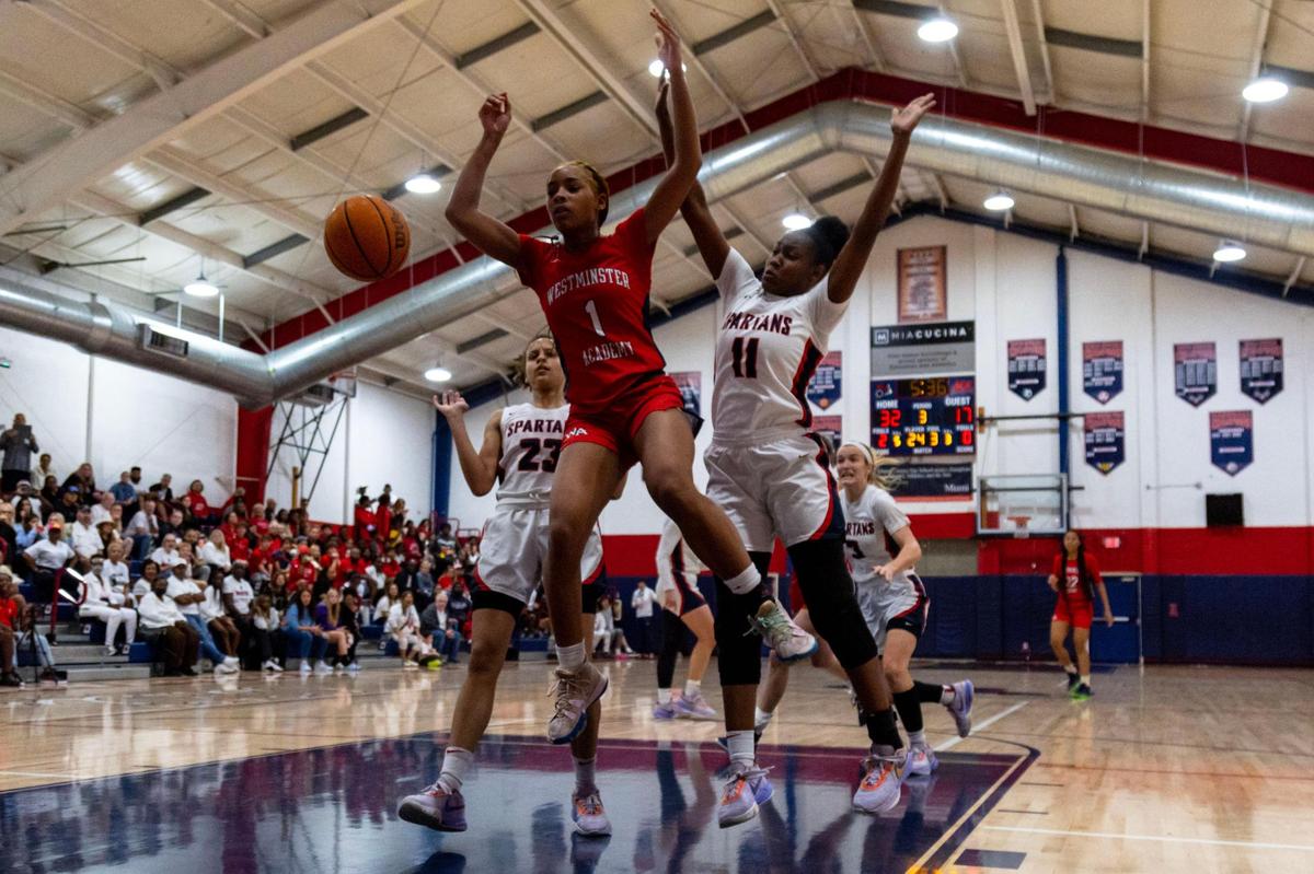Westminster Academy’s Markeli Jones-Tynes (1) loses the ball while defended by Miami Country Day’s Kaliyah Morales (23) and Jada Johnson (11) during the Region 4-3A girls basketball final in Miami, Florida, on Friday, February 17, 2023.